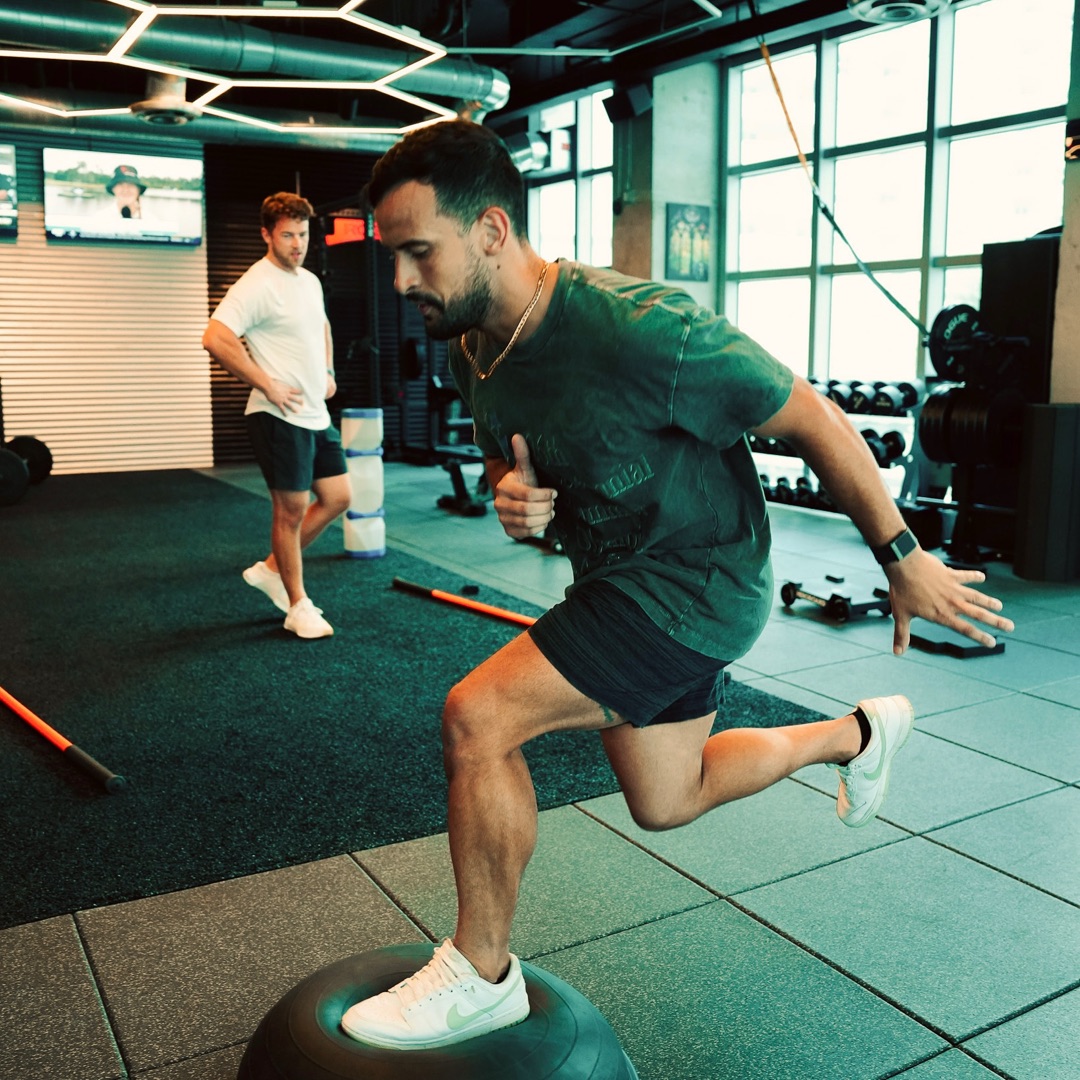 Roger Caibe performing explosive training inside the Crown Performance facility with hexagonal LED lighting