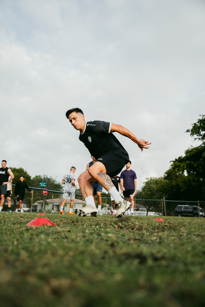 Athlete cutting through agility cones during Crown Performance field session