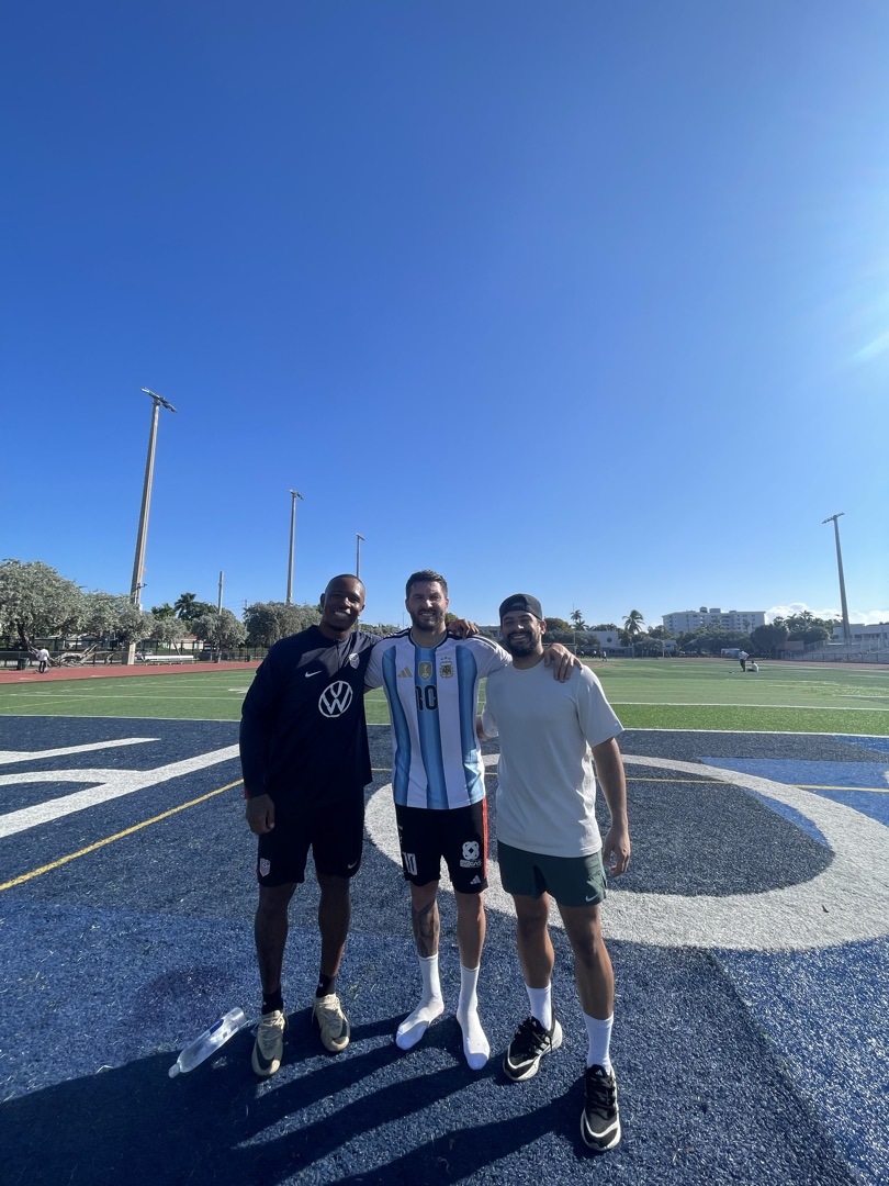 Group photo on the blue turf training field in Miami