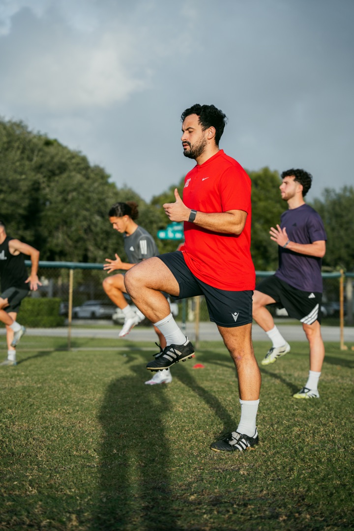 Roger Caibe coaching athletes on the training field